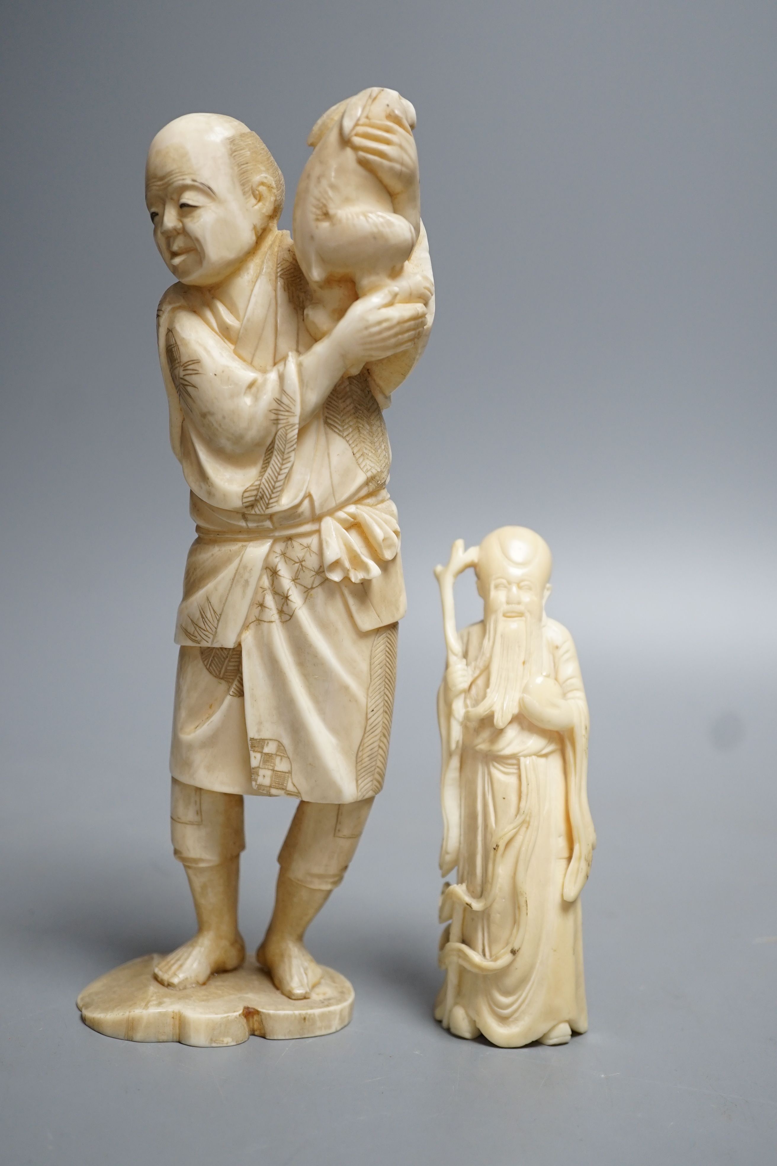 A 19th century Japanese ivory okimono of a man and rabbit together with an early 20th century hippo tooth? Carving of Shou Lao. Largest 19cm